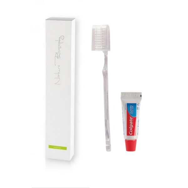 A sleek white box aimed to be a hotel dental set, with a transparent toothbrush and a mini tube of Colgate toothpaste. A premium part of the NATURE PHILOSOPHY hotel toiletries collection, and hotel amenities.