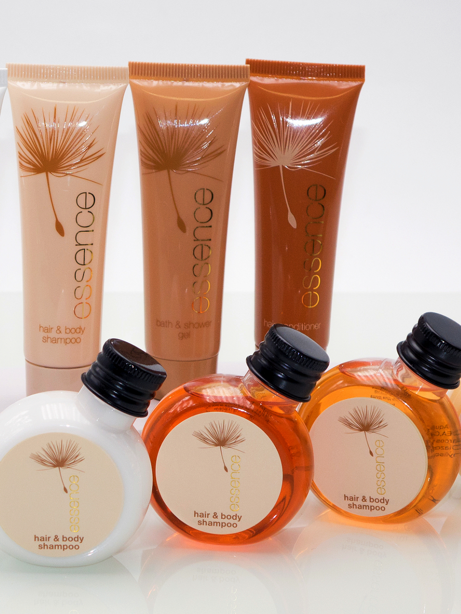 Display of Essence exclusive hotel toiletries brand with elegant sleek brown tubes 30ml offering guests natural and indulgent hotel amenities.