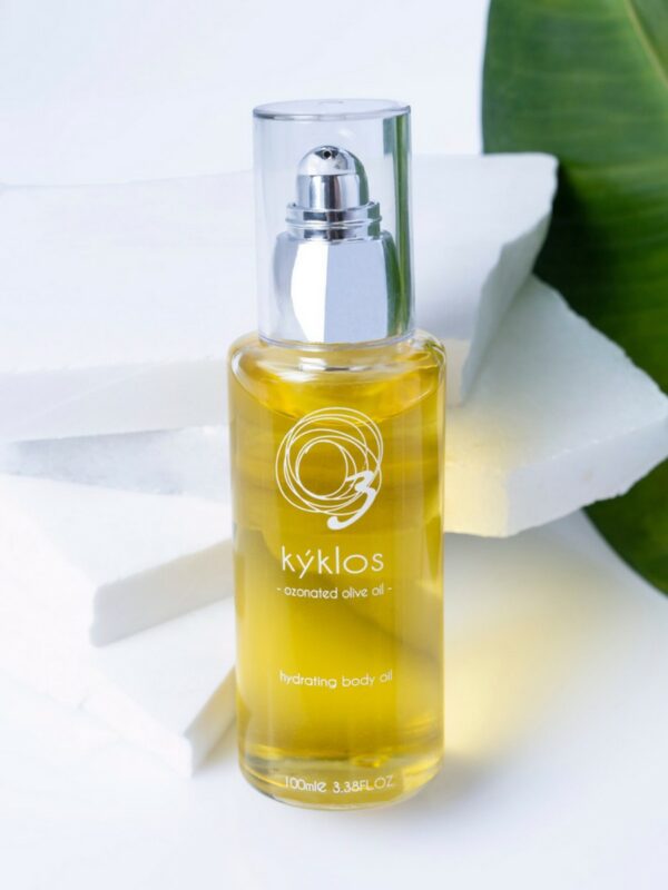 Kyklos hydrating body oil in a clear, sleek glass bottle 100ml with a pump dispenser. This luxurious natural cosmetic contains ozonated olive oil for deep hydration, perfect for nourishing bio and organic skincare routines.