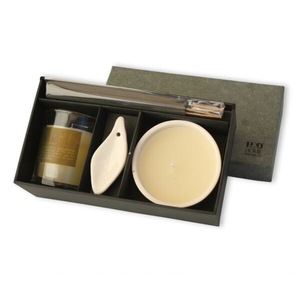 Luxurious scented candles gift box featuring a golden-toned candle, a ceramic candle plate, and a sleek diffuser set for a sophisticated home fragrance.