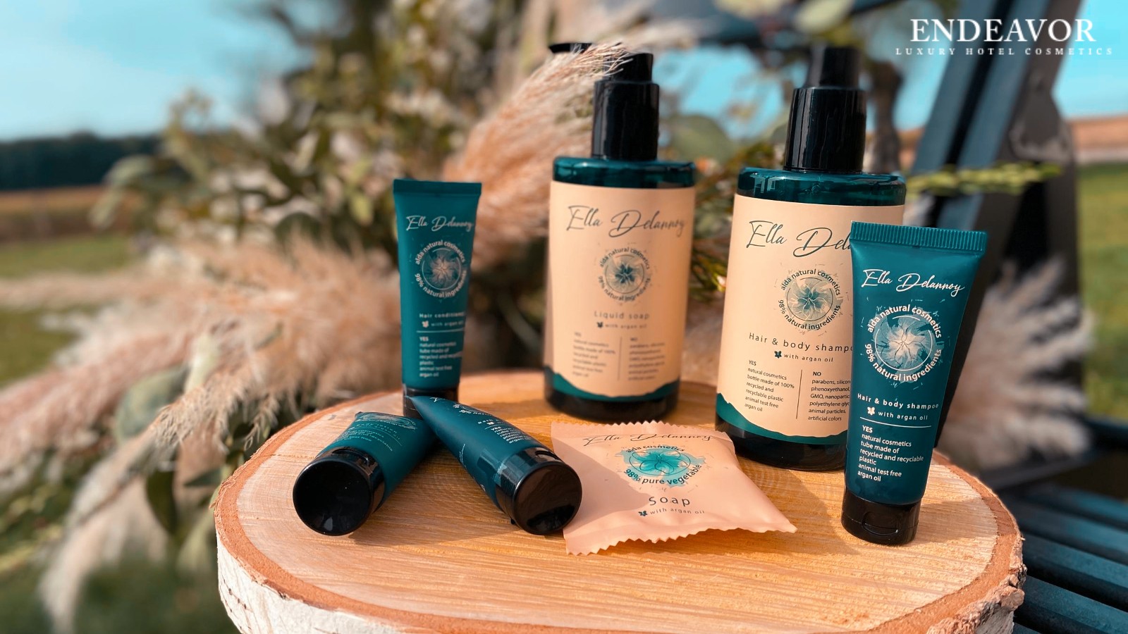 Elegant display of luxury hotel toiletries brand Ella Delannoy. Mini tubes of hair and body shampoo, conditioner, shower gel, a soap bar wrapped in paper and refillable dispenser bottles shampoo, liquid soap.