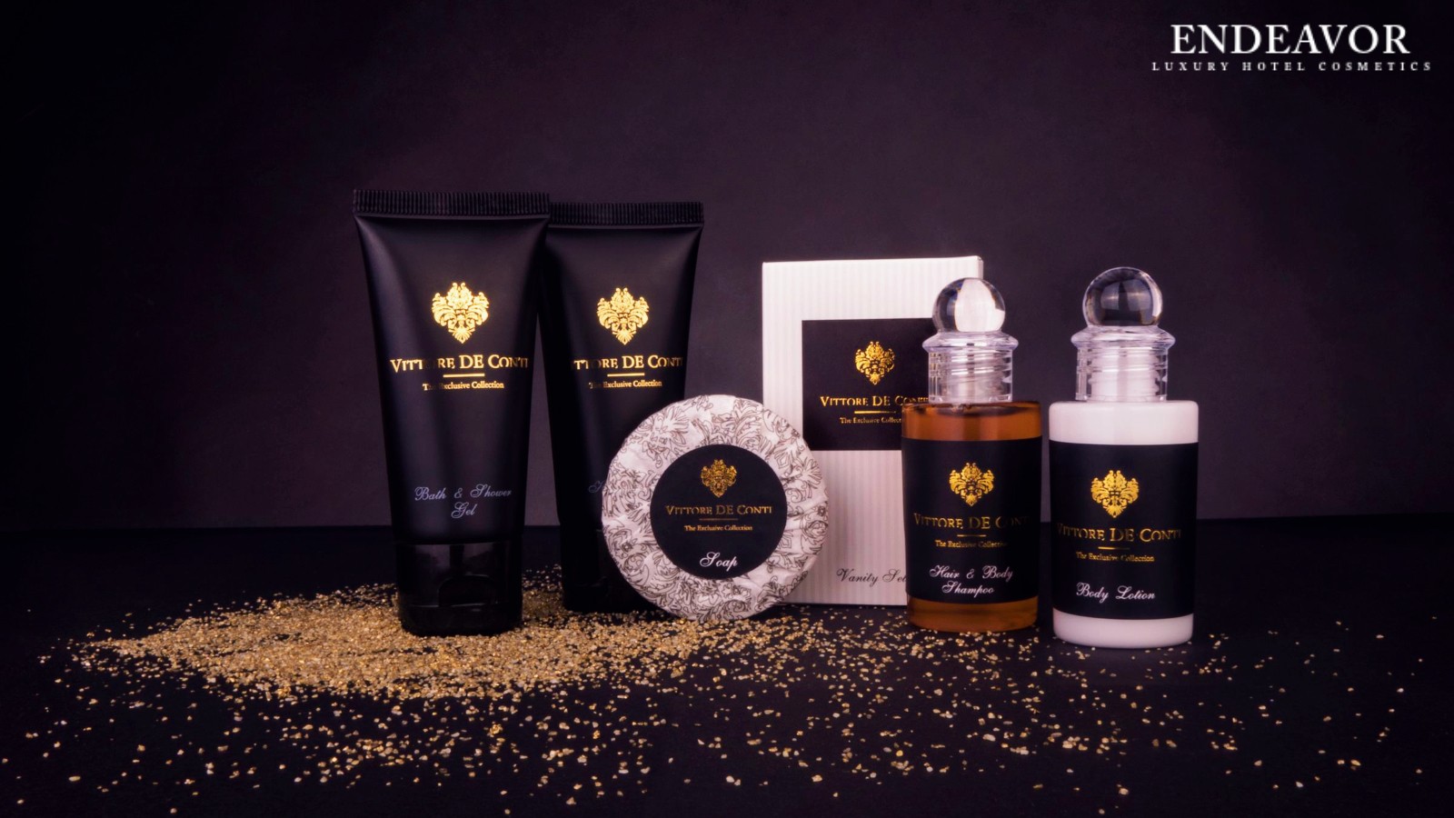 Elegant display of luxury hotel toiletries brand Vittore De Conti. Mini bottles of shampoo, body lotion, a soap bar wrapped in paper and shower gel, body wash, hair conditioner in mini tubes.