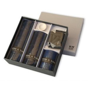 A luxury candle gift set titled 'Intense & Sober,' featuring three dark-toned scented candles in elegant gift box. The set includes three dark-toned scented candles and reed sticks for diffusing fragrances.